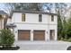 Exterior of home featuring an attached two-car garage and circular driveway at 5245 Kenbrook Way, Sandy Springs, GA 30327