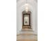 Elegant hallway featuring arched doorways and a large decorative mirror at 5245 Kenbrook Way, Sandy Springs, GA 30327