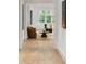 Stylish hallway leading to a bright living area, featuring hardwood floors and tasteful decor at 5245 Kenbrook Way, Sandy Springs, GA 30327