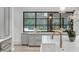 Bright kitchen with a large marble island, wooden floors, and a picturesque view through the expansive window at 5245 Kenbrook Way, Sandy Springs, GA 30327