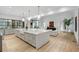 Open-concept kitchen with a large center island with seating and sleek, modern appliances at 5245 Kenbrook Way, Sandy Springs, GA 30327