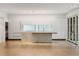 Open floor plan featuring a kitchen with sleek white cabinets and hardwood floors at 5245 Kenbrook Way, Sandy Springs, GA 30327