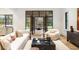 Elegant living room featuring comfortable seating and a seamless transition to an outdoor patio at 5245 Kenbrook Way, Sandy Springs, GA 30327