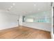 Bright living room featuring hardwood floors, recessed lighting, and a glass partition wall offering a view of the kitchen at 5245 Kenbrook Way, Sandy Springs, GA 30327