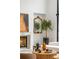 Bright living room featuring a fireplace with a marble mantel, art and decor, and a large window at 5245 Kenbrook Way, Sandy Springs, GA 30327