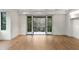 Bright living room with hardwood floors, a window with black trim, and glass doors opening to a balcony at 5245 Kenbrook Way, Sandy Springs, GA 30327