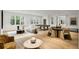 Expansive living room with hardwood floors, multiple seating areas, and ample natural light at 5245 Kenbrook Way, Sandy Springs, GA 30327