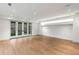 Bright and spacious living room with hardwood floors, recessed lighting and glass doors to the backyard at 5245 Kenbrook Way, Sandy Springs, GA 30327