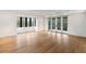 Bright living room featuring hardwood floors, natural lighting from the windows, and glass doors to the outside at 5245 Kenbrook Way, Sandy Springs, GA 30327