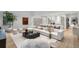 Bright living room featuring a large sectional sofa, hardwood floors, and an open layout to the kitchen at 5245 Kenbrook Way, Sandy Springs, GA 30327