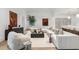 Spacious living room featuring modern decor, plush seating, and stylish art at 5245 Kenbrook Way, Sandy Springs, GA 30327