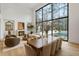 Bright living room with a large window, fireplace, and dining area, perfect for entertaining and relaxation at 5245 Kenbrook Way, Sandy Springs, GA 30327
