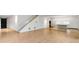 Large and open living space with hardwood floors, stairs, and a modern kitchen at 5245 Kenbrook Way, Sandy Springs, GA 30327
