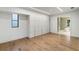 Bedroom with built-in cabinets and hardwood floors, leading into a luxurious bathroom with a soaking tub at 5245 Kenbrook Way, Sandy Springs, GA 30327