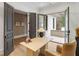 A bright home office with French doors leading to an outdoor patio area with natural lighting at 5245 Kenbrook Way, Sandy Springs, GA 30327