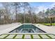 Beautiful outdoor living area with a large in-ground pool and lush landscaping at 5245 Kenbrook Way, Sandy Springs, GA 30327
