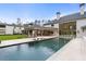 Backyard featuring a large pool, covered patio, and well-manicured landscaping at 5245 Kenbrook Way, Sandy Springs, GA 30327