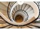 Unique spiral staircase with a black metal railing and light wood steps at 5245 Kenbrook Way, Sandy Springs, GA 30327