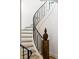 Elegant staircase featuring modern black railings, neutral steps, and a decorative vase at 5245 Kenbrook Way, Sandy Springs, GA 30327