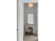 Built-in vanity nook featuring sconces, a decorative mirror, and a comfortable chair at 5245 Kenbrook Way, Sandy Springs, GA 30327