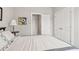 Bedroom with a side table and decorative lamp, double closet, and attached bath entry at 5726 Taylor Way, Sandy Springs, GA 30342