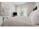 Bright bedroom with natural light, modern art, neutral carpet, and a metal bed frame at 5726 Taylor Way, Sandy Springs, GA 30342