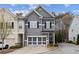 Inviting gray two-story townhome boasting a two-car garage and neat landscaping at 5726 Taylor Way, Sandy Springs, GA 30342