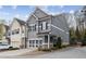 Stunning gray two-story townhome featuring a two-car garage and meticulous landscaping at 5726 Taylor Way, Sandy Springs, GA 30342