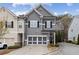 Charming two-story townhome with gray siding, black shutters, and a two-car garage at 5726 Taylor Way, Sandy Springs, GA 30342
