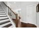 Staircase view showing wood floors and modern metal railing detail with an open view to living spaces at 5726 Taylor Way, Sandy Springs, GA 30342