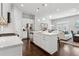 Open kitchen featuring white cabinets, stainless steel appliances, and an island with bar stools at 5726 Taylor Way, Sandy Springs, GA 30342