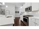 Modern kitchen featuring white cabinets, stainless steel appliances, and quartz countertops at 5726 Taylor Way, Sandy Springs, GA 30342