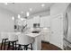 Modern, all-white kitchen with stainless steel appliances and a large island with bar seating at 5726 Taylor Way, Sandy Springs, GA 30342