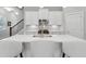 Bright kitchen with white cabinets, stainless steel appliances, and a large quartz countertop island at 5726 Taylor Way, Sandy Springs, GA 30342