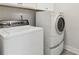 Bright laundry room featuring white washer and dryer at 5726 Taylor Way, Sandy Springs, GA 30342