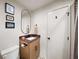 Stylish bathroom with a unique oval mirror, patterned tile floor, and updated fixtures at 595 Overbrook Nw Dr, Atlanta, GA 30318