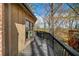 Long wood deck featuring wood railings and exterior of home with many trees surrounding at 595 Overbrook Nw Dr, Atlanta, GA 30318