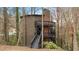 Three-story home with multi-level decks and black railings at 595 Overbrook Nw Dr, Atlanta, GA 30318