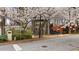 Unique home design with blooming trees in a wooded setting, featuring multi-level decks and a combination of wood and brick finishes at 595 Overbrook Nw Dr, Atlanta, GA 30318