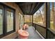 Outdoor porch with two comfortable chairs and a view of the surrounding trees at 595 Overbrook Nw Dr, Atlanta, GA 30318