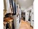 Walk-in closet with shelving and a full-length mirror and stacked washer/dryer at 595 Overbrook Nw Dr, Atlanta, GA 30318