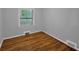 Simple bedroom featuring hardwood floors, two windows, and neutral-colored walls at 656 Channing Nw Dr, Atlanta, GA 30318