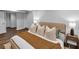 Well-lit bedroom with a comfortable bed, a decorative throw and a side table with a lamp at 656 Channing Nw Dr, Atlanta, GA 30318