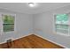 Cozy bedroom with hardwood floors and sun-filled windows overlooking nature at 656 Channing Nw Dr, Atlanta, GA 30318