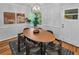 Cozy dining room featuring hardwood floors, modern light fixture, and dining table set for six at 656 Channing Nw Dr, Atlanta, GA 30318