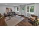Bright living room features hardwood floors, neutral walls, ample natural light, and modern furnishings at 656 Channing Nw Dr, Atlanta, GA 30318