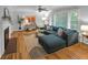 Stylish living room featuring a fireplace, hardwood floors, large sectional sofa, and ample natural light at 656 Channing Nw Dr, Atlanta, GA 30318