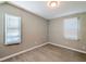 A quiet, bright room with two windows, wood-look flooring, and neutral walls at 1672 Thornton Pl, Atlanta, GA 30315