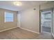 Inviting bedroom featuring wood-look floors, a window, and adjacent kitchenette offering flexible living at 1672 Thornton Pl, Atlanta, GA 30315