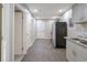 Open-concept kitchen area with modern appliances, gray cabinetry, and vinyl flooring at 1672 Thornton Pl, Atlanta, GA 30315